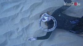 Snorkeler blows perfect bubble rings from sea bed