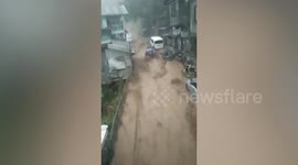 Flash floods sweep away vehicles during catastrophic rain in the Philippines