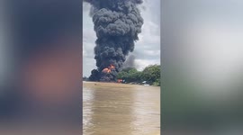 Fuel tanker ship catches fire next to town on river in Myanmar