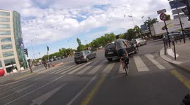 A cyclist is cut off by a car turning right. Paris, Porte d'Orléans, France. 13 july 2022