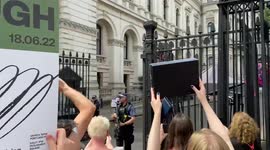 Protesters play “Bye Bye Boris” outside Downing St as Boris Johnson leaves for PMQs