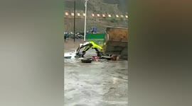 Police officer saves motorists trapped in car submerged in deep floodwater in China