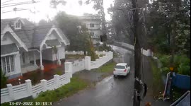 Narrow escape for a car and a two-wheeler rider as tree and electric pole CRASH right in front of them