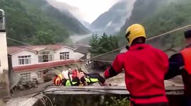 Firefighters use zipline to rescue infant trapped in flooded house in southern China