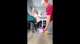 Determined dad helps partially paralyzed daughter with practicing standing INSPIRATIONAL
