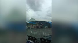 Gusty winds batter tents at flea market in Thailand