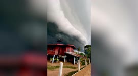 Ominous storm cloud hovers over homes in Thailand