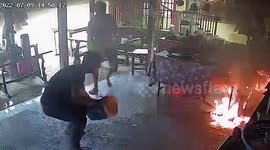 Panicked residents splash buckets of water to put out fire in cafe