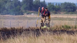 Fire brigade remain onsite after grass fire during Heatwave in Kent, UK