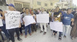 Palestinian workers take part in a protest against the decision to freeze their permits in front of the Civil Affairs