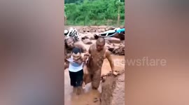 Man carries woman away after mudslide lands on passing taxi in southern China