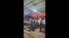 Woman using her head to lift a giant drum with a 75kg man spinning in circles for 30 seconds