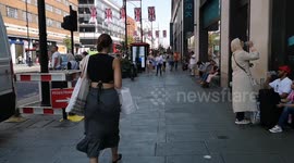 Hot Weather In London Causes Londoners To Hide in The Shade Of Primark In Oxford Street