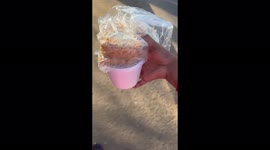 Woman donates food in the street on Mandela Day in Alexandra, South Africa