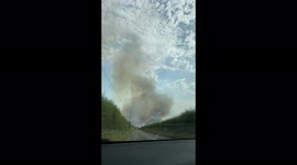 Huge smoke cloud from fire in a wheat field during UK heatwave
