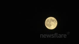 Plane Flies past Super Moon in London