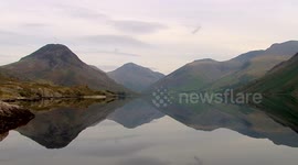 Beautiful lake perfectly reflects mountain in the Lake District, UK