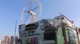 Giant Ferris wheel installed on building roof in Shanghai