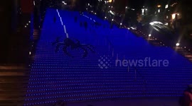 Spiders crawl down stairs in cool light show at Kyoto station