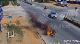 Scooter bursts into flames after crashing into car