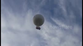 Flying caravan floats above UK field