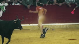 Man stripped naked by a bull