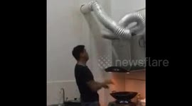 Cooking man's hilarious reaction to falling pipe