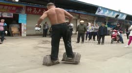 55-year-old muscle man wears pair of 50kg stone locks to exercise