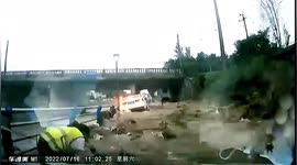 Floodwater knocks over scooter riders after wall collapses in eastern China