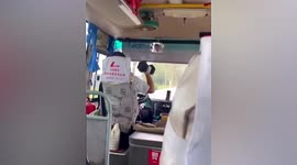 Workout at the wheel! Coach driver lifts dumbbell whilst driving in China