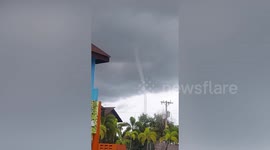 Long thin waterspout forms off Philippines coast spawning heavy rain and thunderstorm