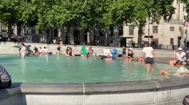 People cool down in the fountains at Trafalgar Square on the hottest day in history