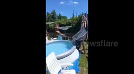 Builder dad handcrafts rollercoaster-like water slide in his back garden so his kids can beat the heatwave