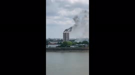 Firefighters battle to extinguish tower block flat in east London