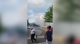 Police seen dispersing bystanders after fire breaks out at top of 17-storey London tower block