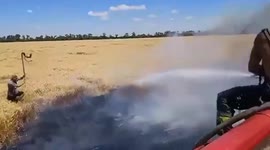 Ukrainian firefighters and farmers battle crop fires caused by Russians bombing fields