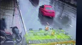 Incredible near miss! Watch moment motorcyclist evades garbage truck in wet conditions in Thailand
