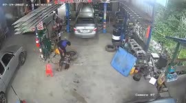 Tyre explodes and hits ceiling at mechanic's garage in Thailand