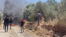 Palestinian protesters clash with Israeli forces during a demonstration against settlements in the village of Beita