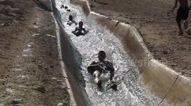 Palestinians cool off in river amid soaring temperatures in West Bank