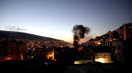 Smoke rises from a home of Palestinian Mohammad Al-Azizi during an Israeli military operation
