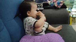 Funny actions of a one-year-old sucking her own toes
