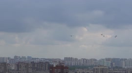 Helicopters fly over city coming back from the air rehearsal for Navy Day in St Petersburg, Russia