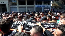 Mourners carry the bodies of two Palestinians killed by Israeli forces, during funeral in Nablus