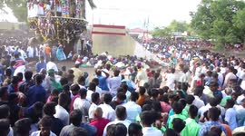 Brave locals collect coconuts being thrown at wall by thousands of devotees in India