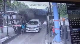 Terrifying CCTV of the moment cement-laden truck slams into toll booth and overturns in India