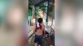 Water gushes down waterfall in front of shocked park visitors