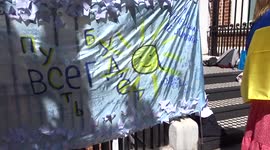 Let The Sun Be Forever placard sends a message of peace at Russians Against The War rally outside the Embassy of Russia in London