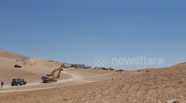 Israeli machineries demolishe a Palestinian house, in the West Bank city of Hebron