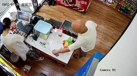 Elderly Chinese man calmly steals shop owner's phone when paying for water